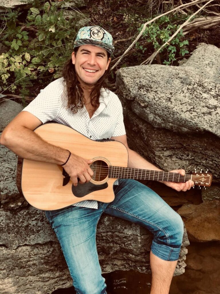 Stoney Banks with acoustic guitar